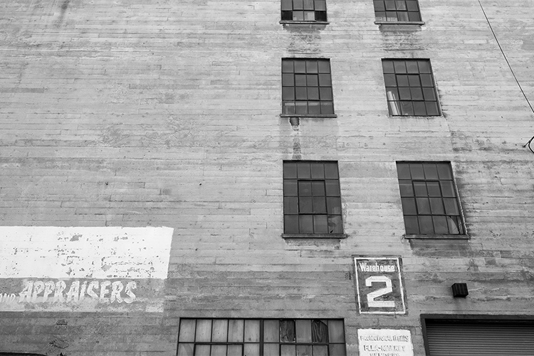 Building at Pier 70 with faded 'Appraisers' advertisement mural, San Francisco.  R. Blum and Associates Commercial Real Estate Appraisal. Photo 2014.